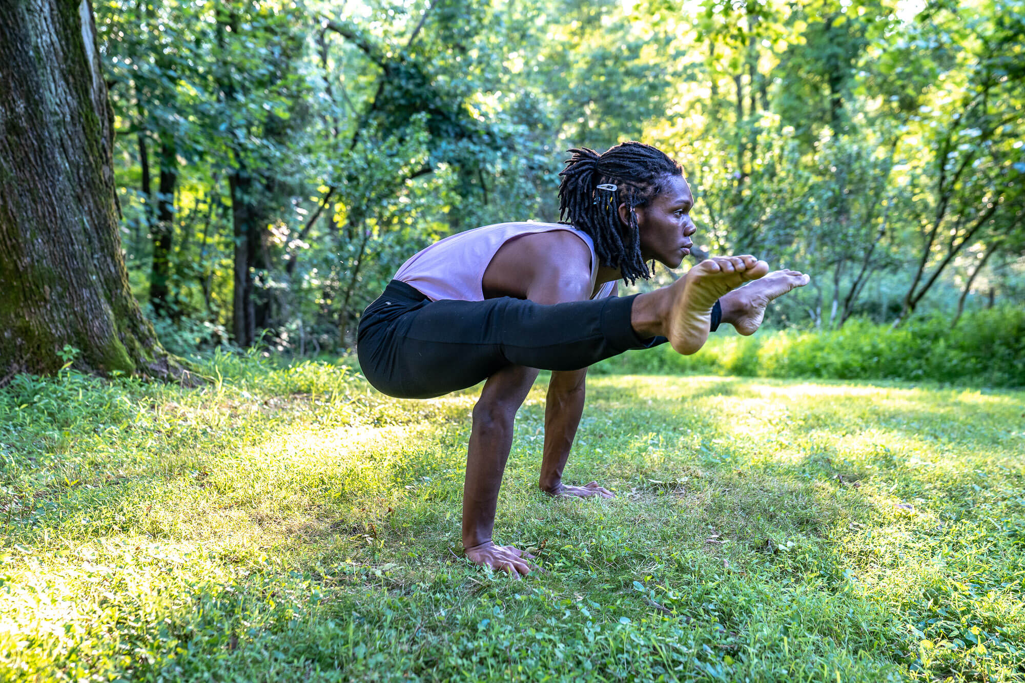 Vinyasa Teacher Training 4 - Taryn Vander Hoop Female student doing yoga pose on two hands with legs pointed forward