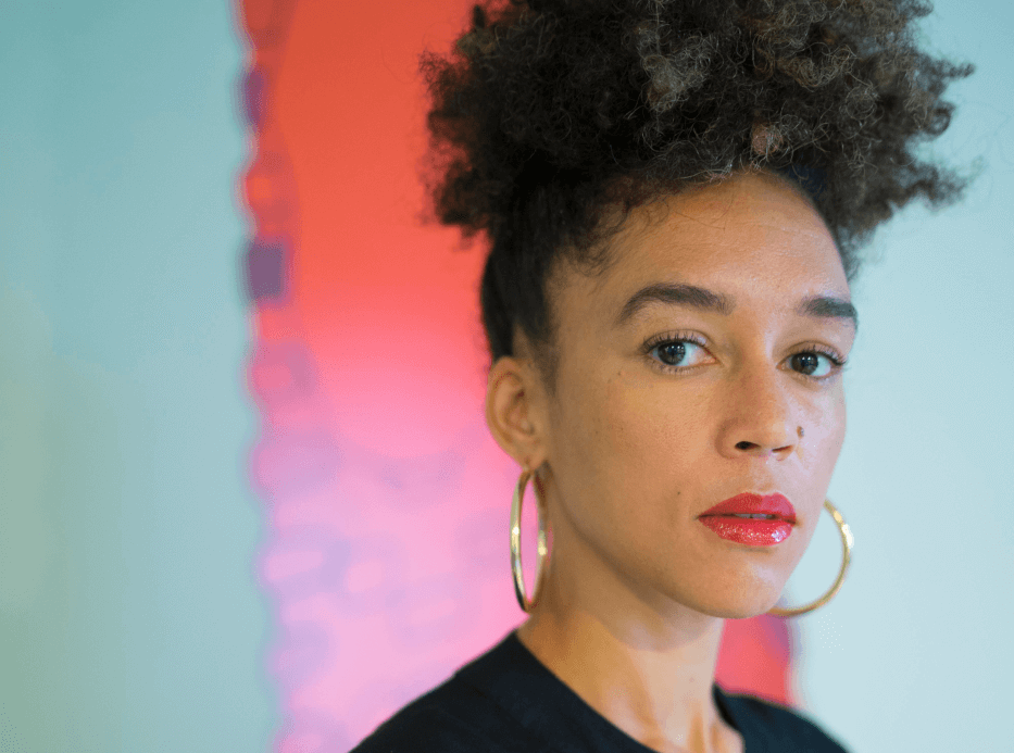 Woman with big hoop earrings looking into camera