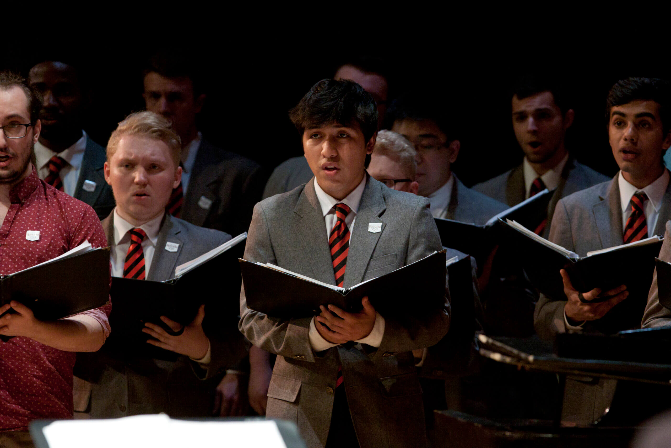 Members of the Glee Club perform on stage. 