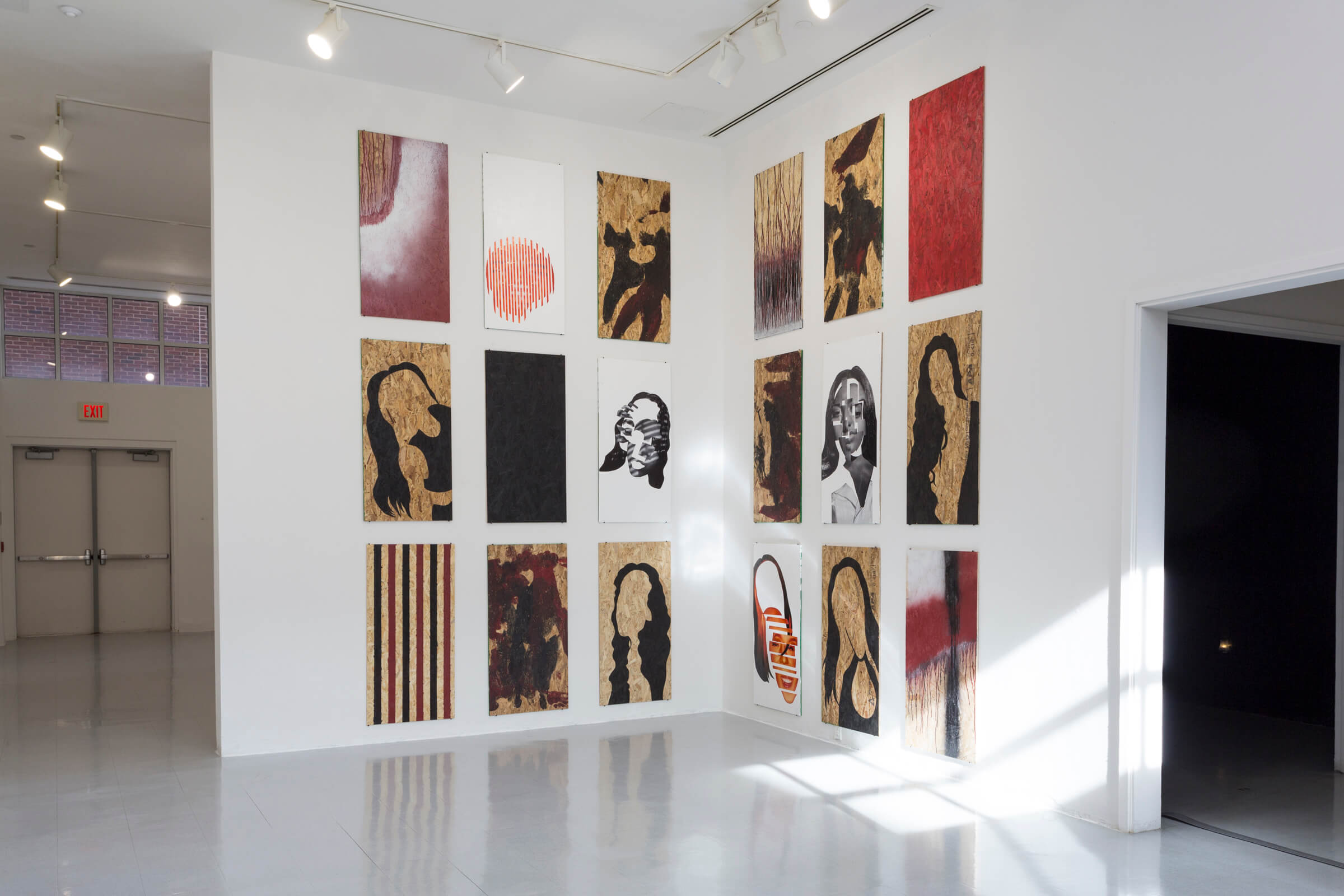 Nine rectangular pieces of artwork on one wall and nine pieces of rectangular artwork on the adjacent wall in a gallery.