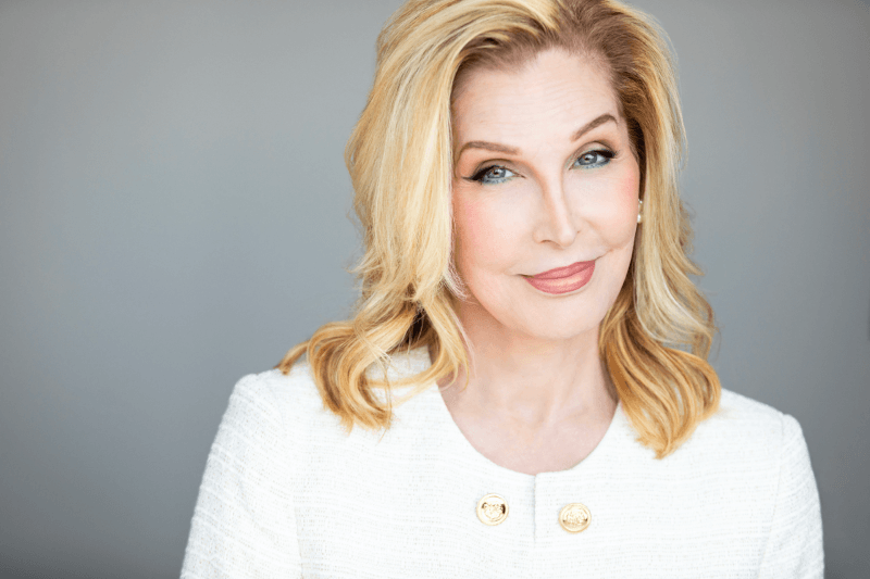 Headshot of Bianca Leigh wearing a white jacket