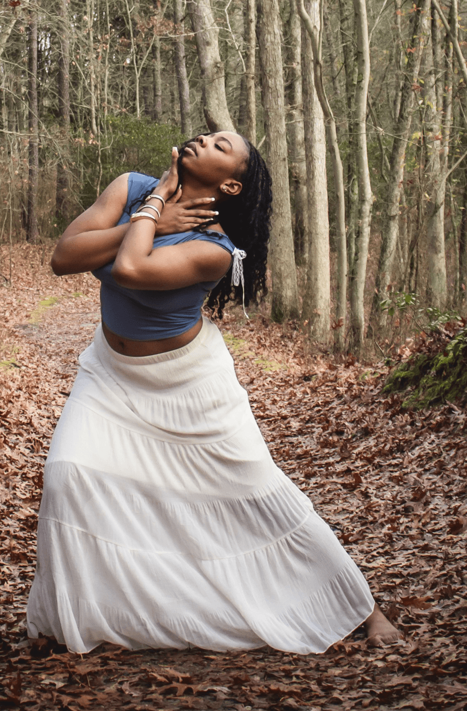 Woman holding dancing pose in woods